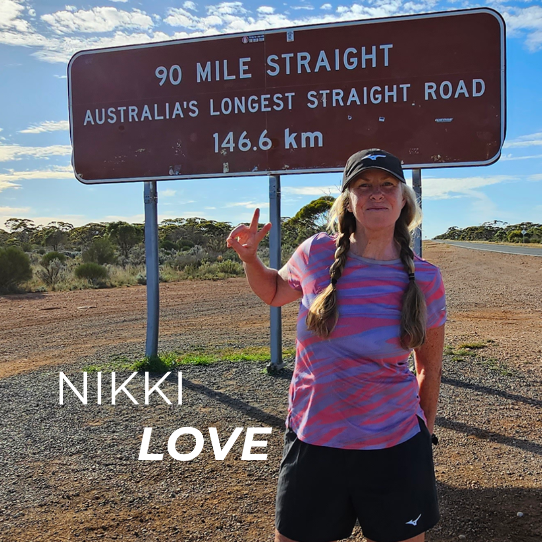 Brand Ambassador Nikki Love picture in Australia in front of a road sign.