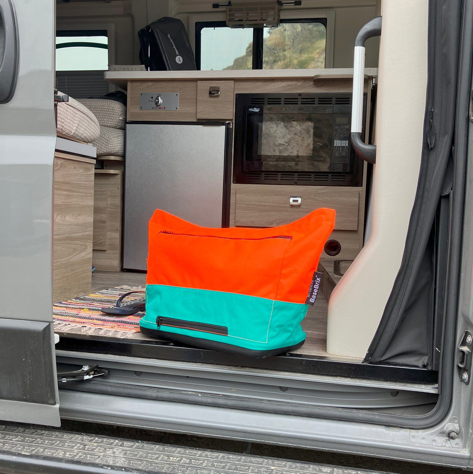 Camping-ready tote bag with a waterproof base and large capacity, perfect for carrying tents, blankets, and food