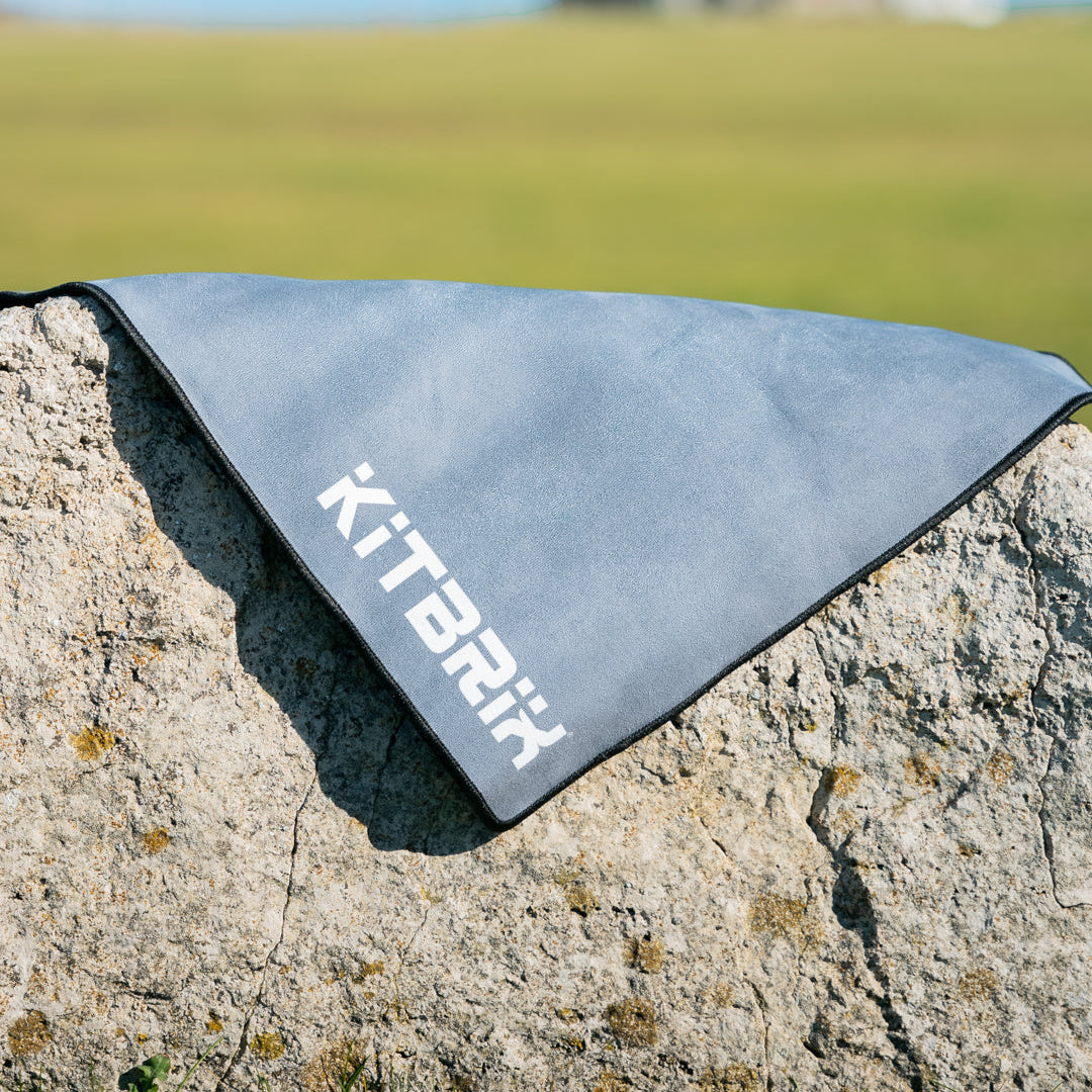 Triathlon transition mat with microfiber suede top and black natural rubber base.