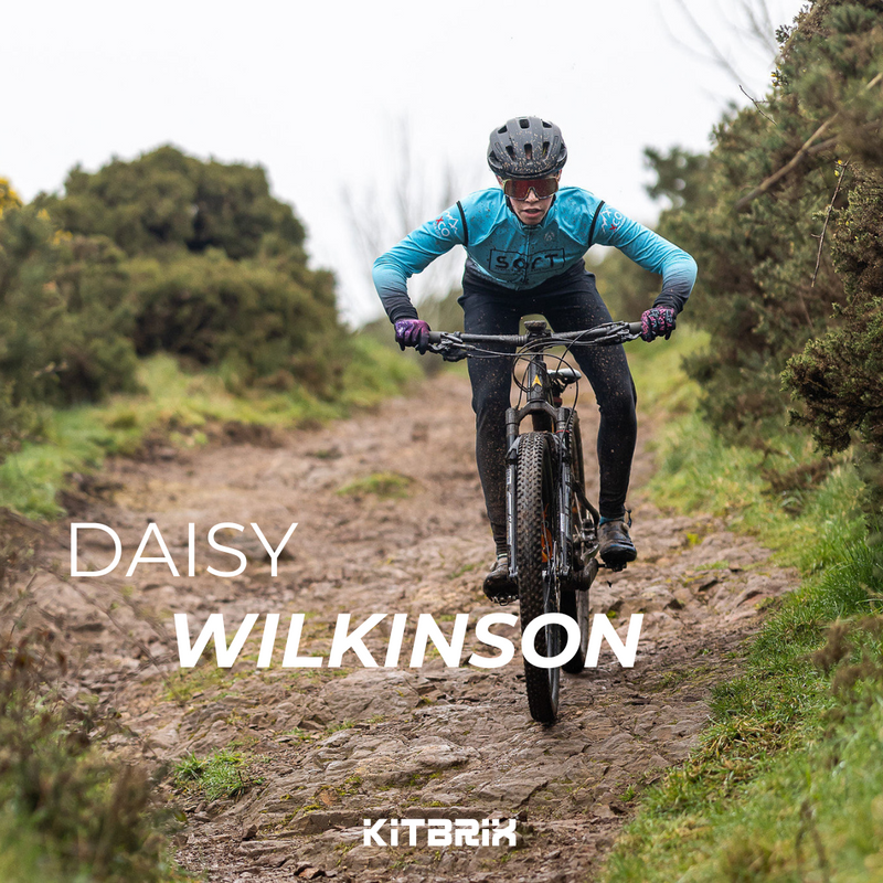 Kitbrix Brand Ambassador wearing bright blue cycling kit on the top of a hill on her mountain bike