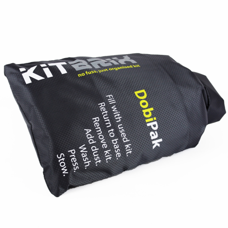 DobiPak being easily carried to the washing machine, demonstrating its convenience for transporting wet items.