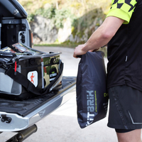 A person holding the Dobi dry bag, emphasizing its lightweight and portable design for easy transport of wet kit.